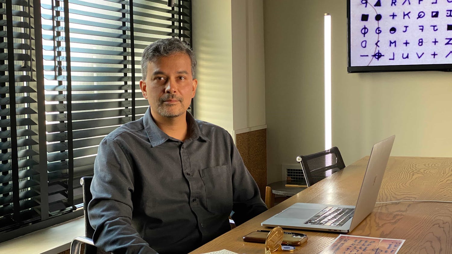 Man sat at desk with laptop