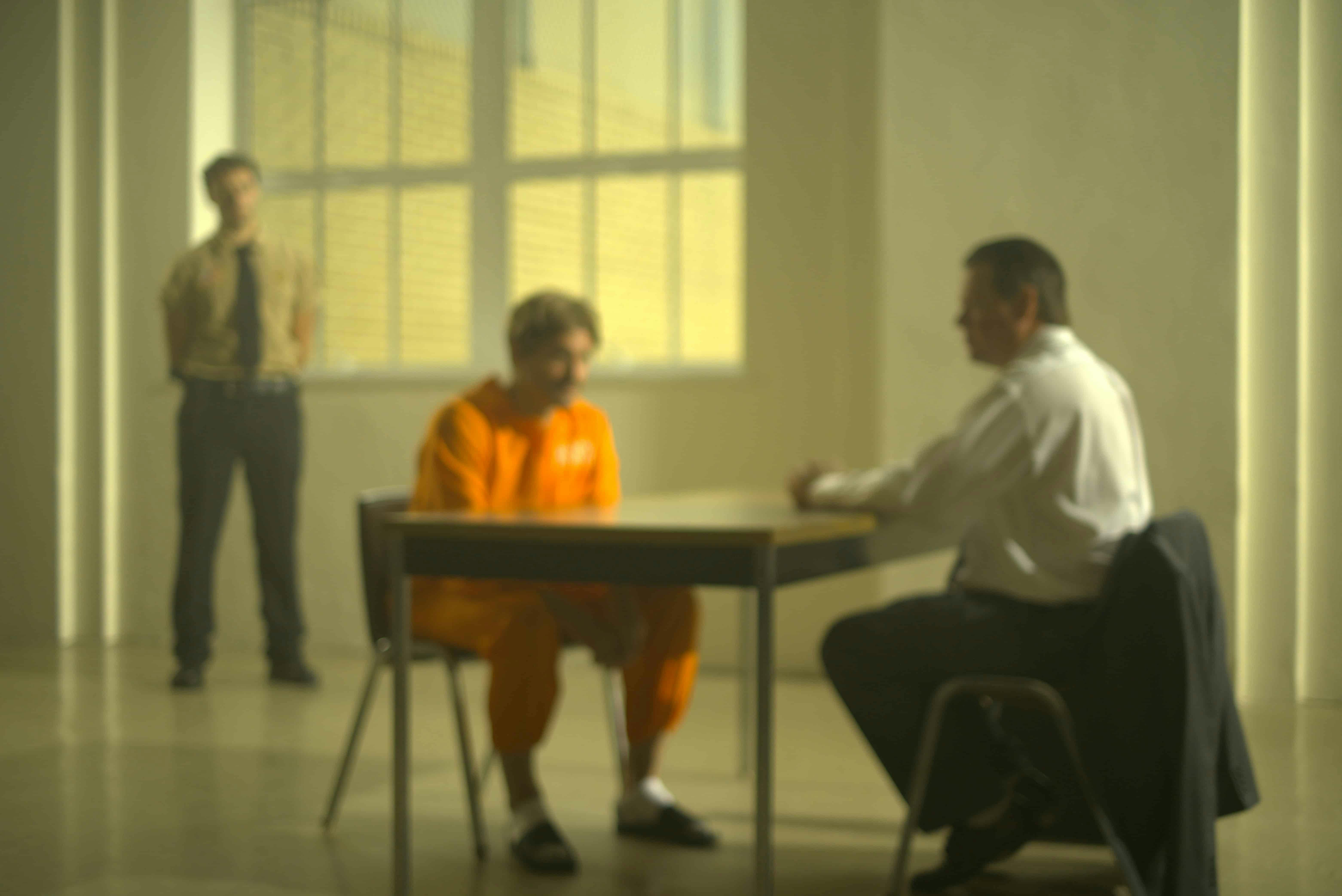 Prisoner being interviewed by detective