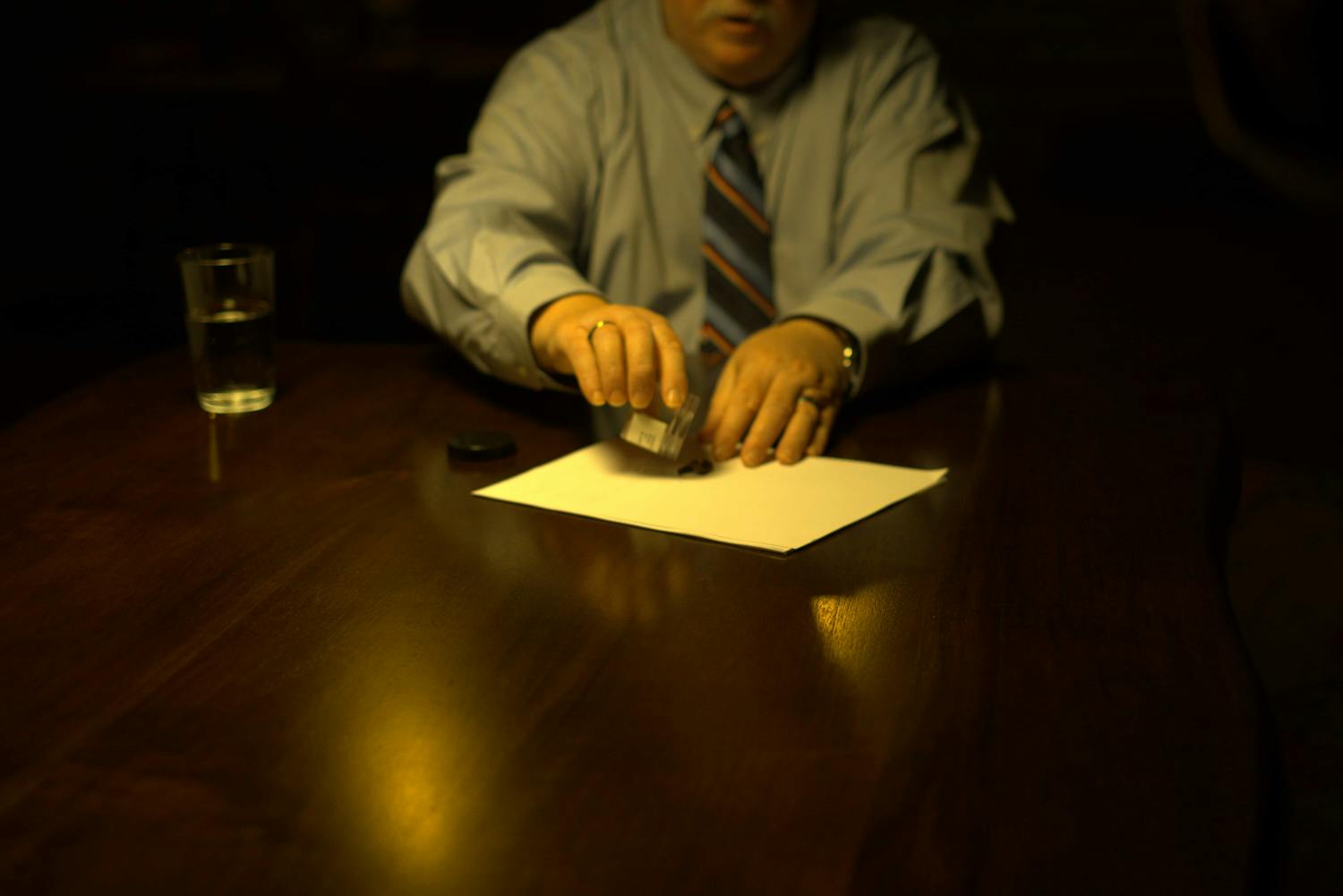 Man stamping something onto a piece of paper