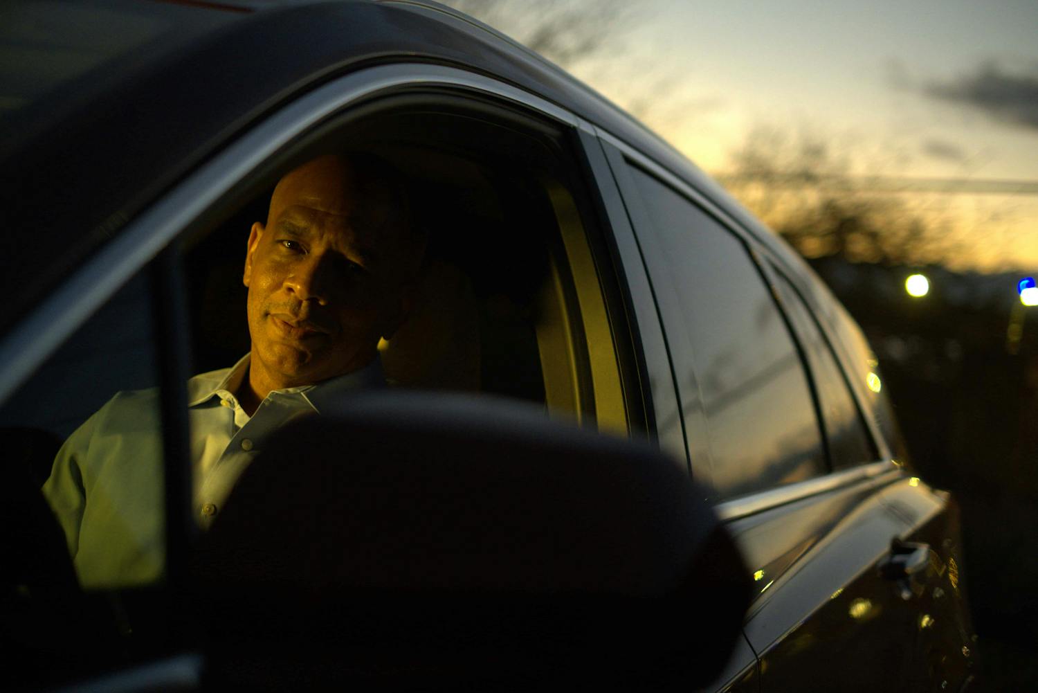 Man with serious expression looking out of car window