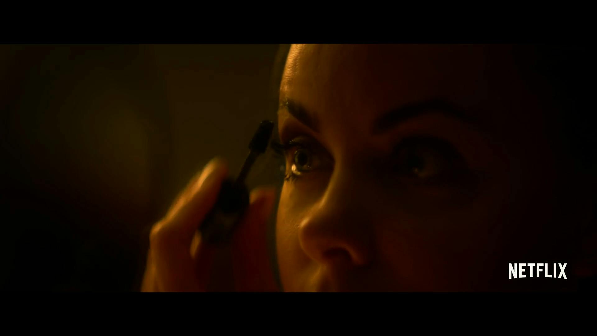 Woman applying mascara