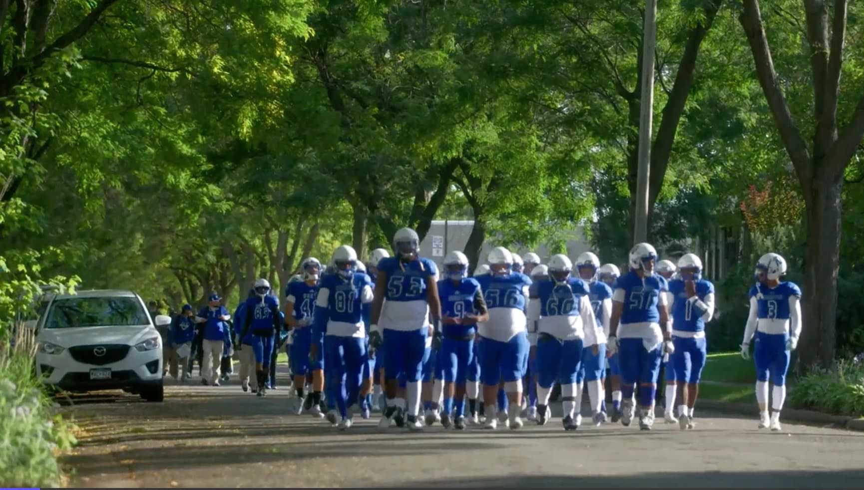 Team of football players walking