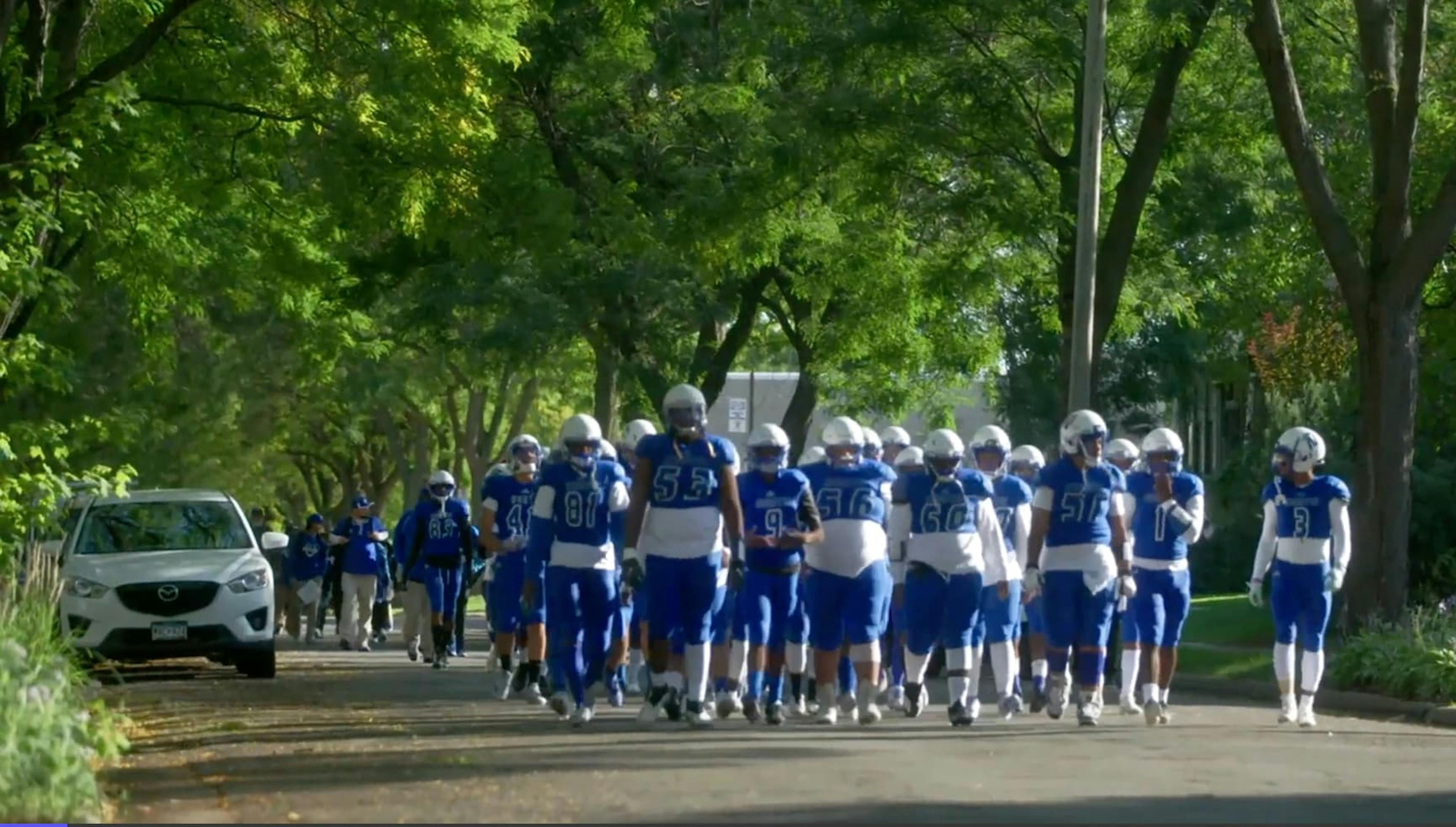Team of football players walking