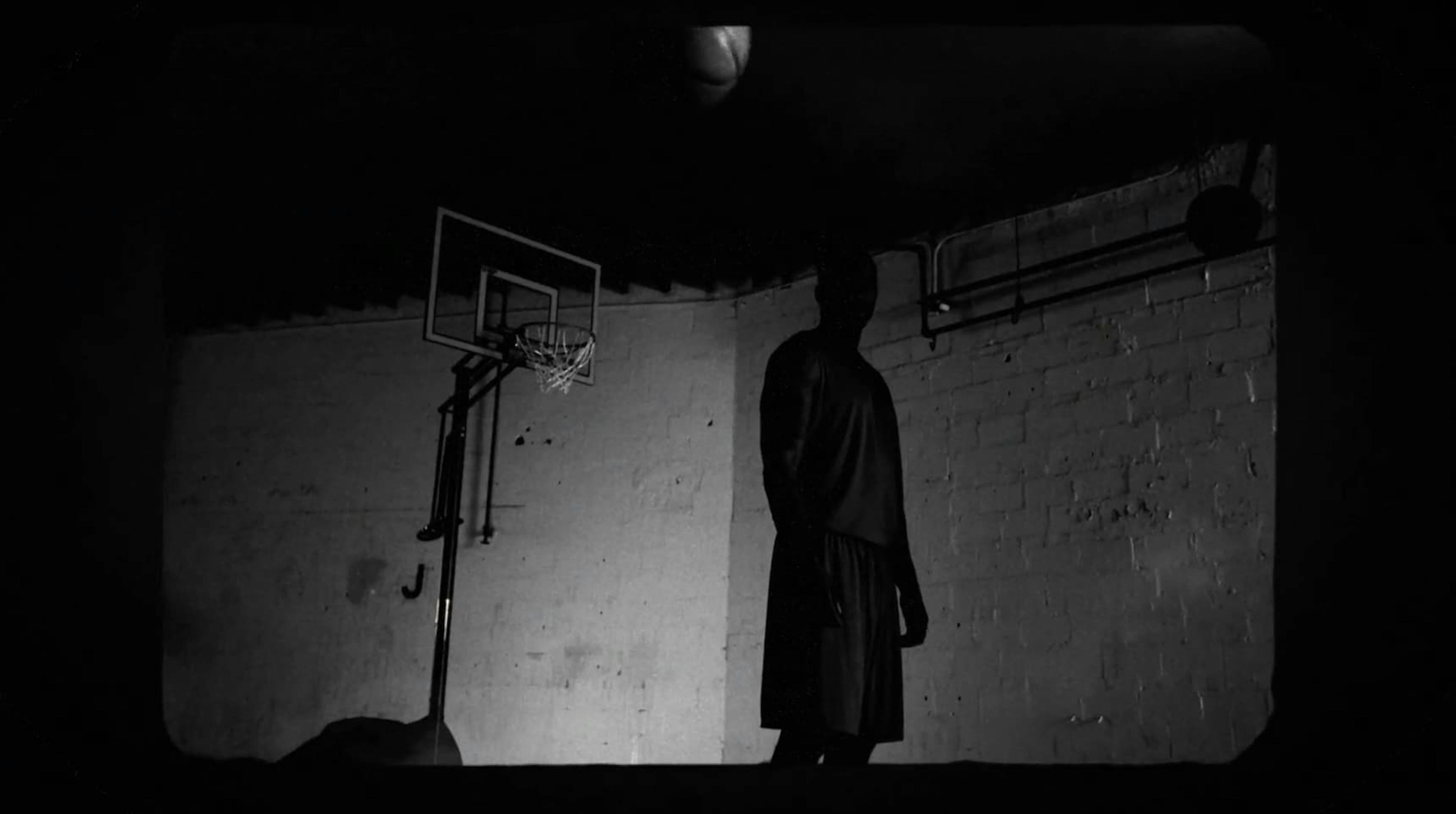 Man stood by basketball hoop