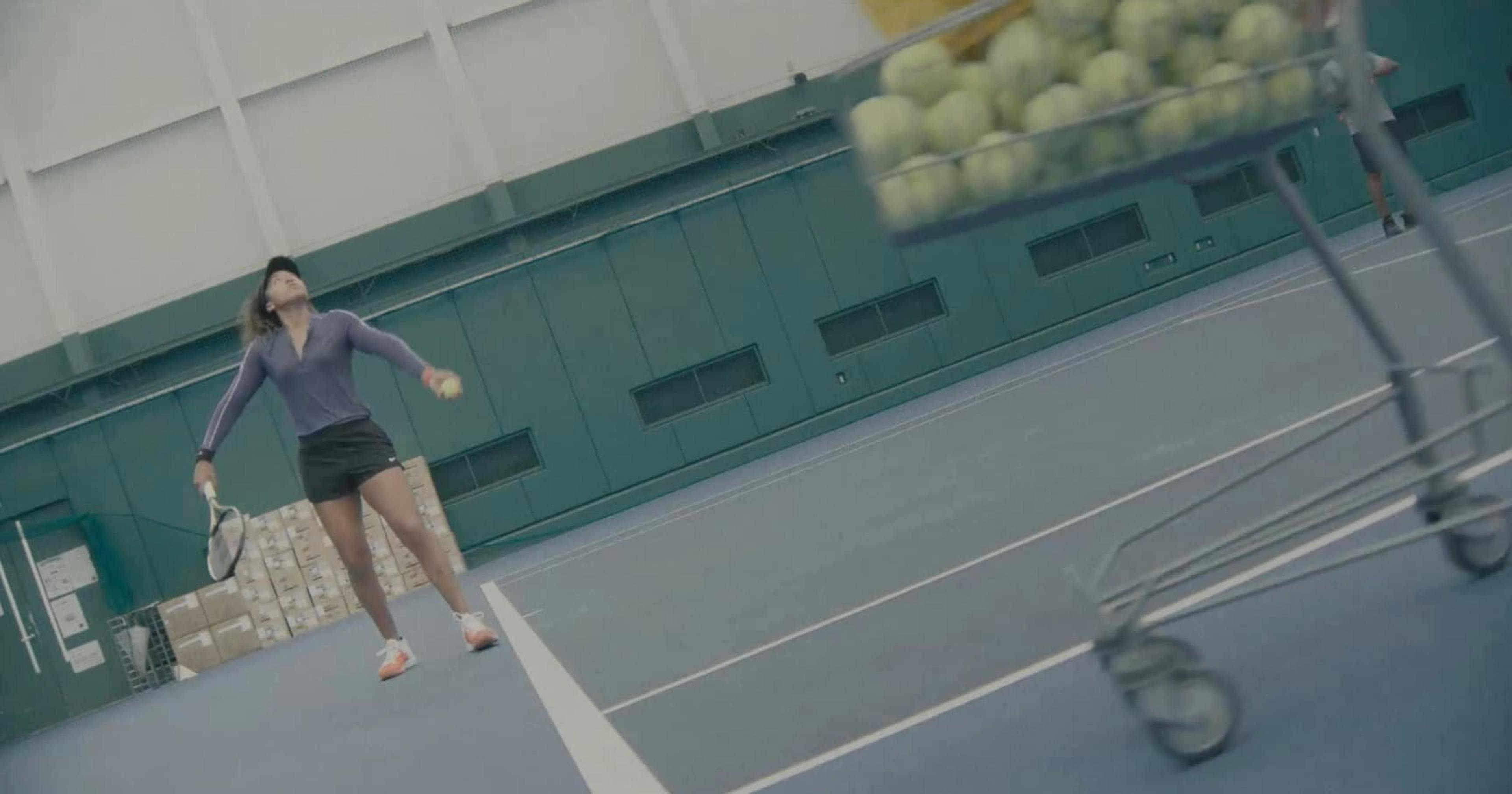 Girl hitting tennis balls