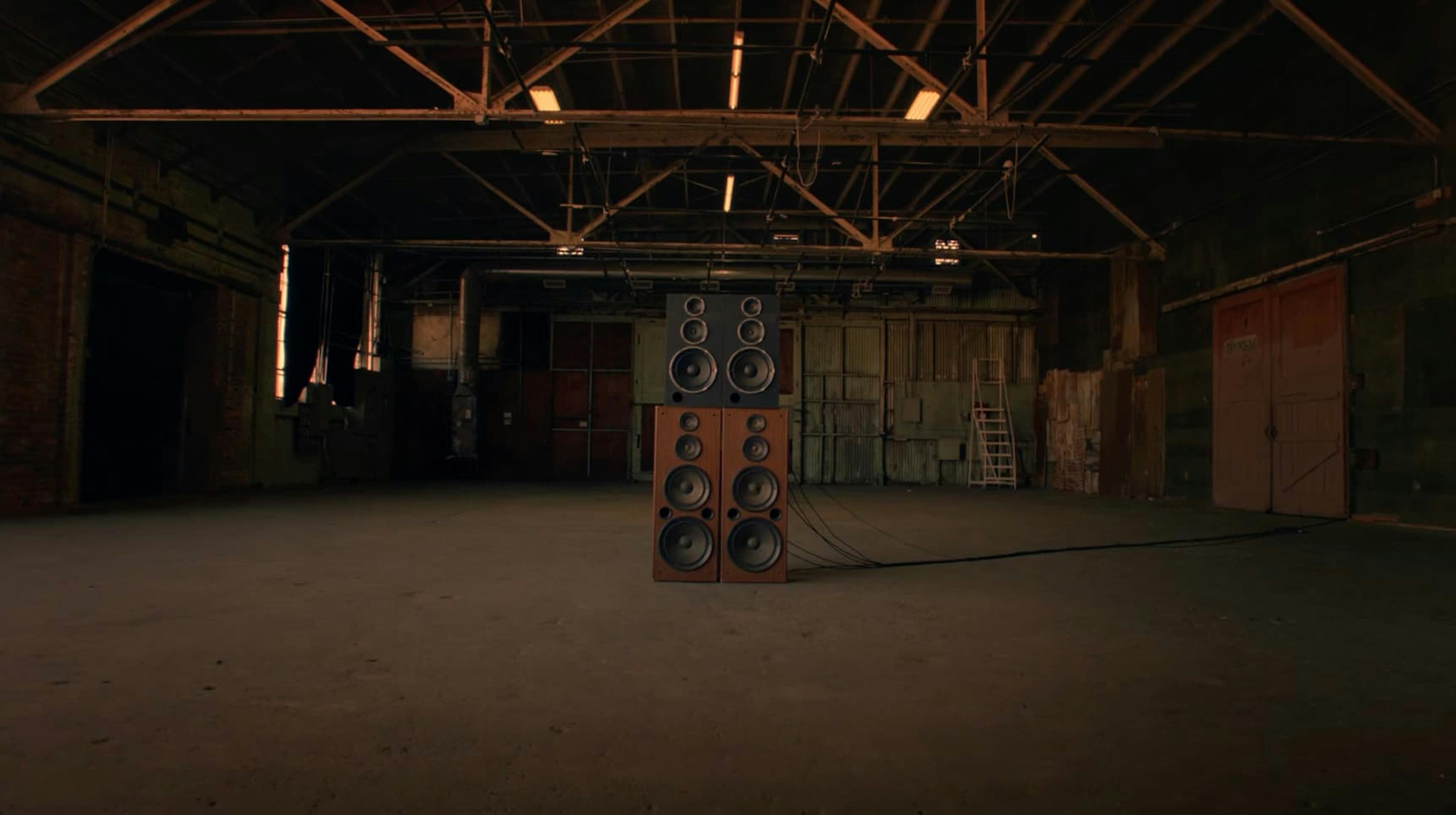 Speakers in middle of floor in warehouse