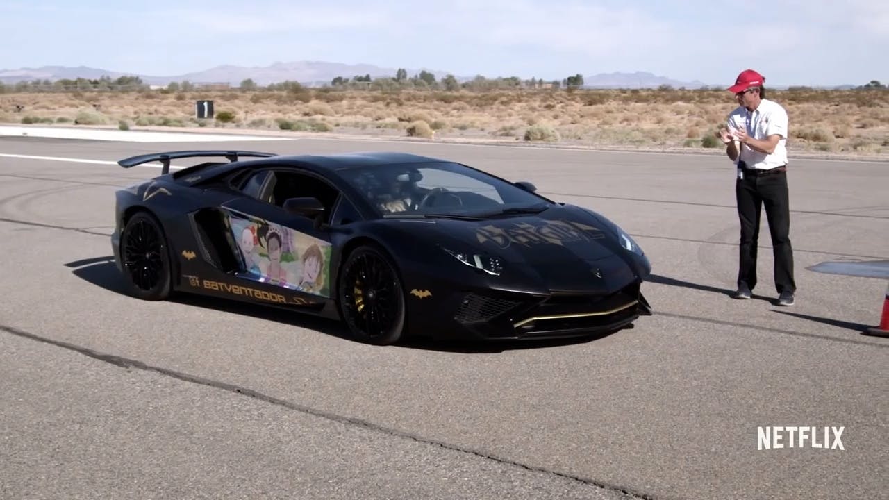 Man stood next to sports car