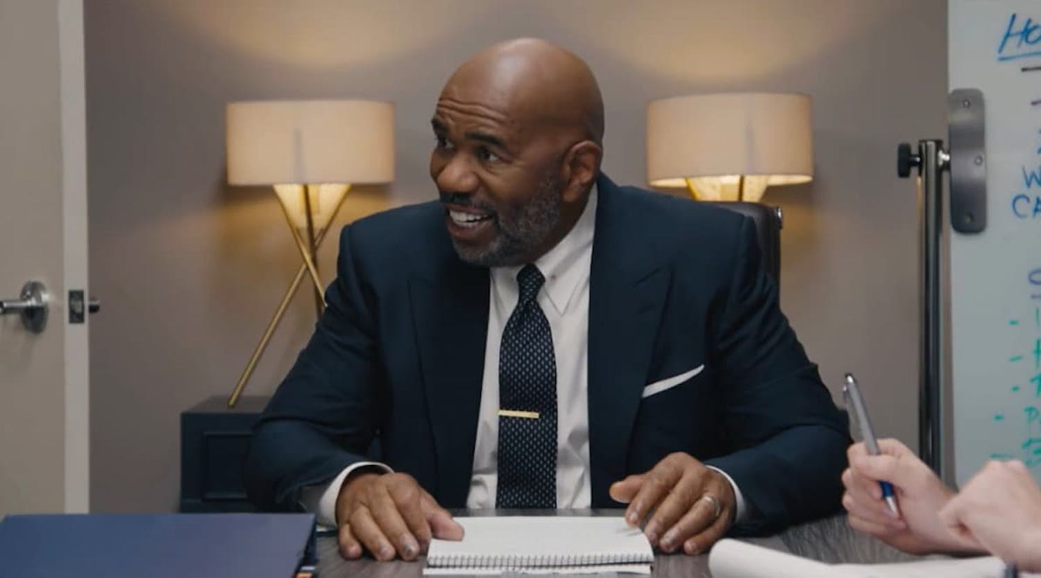 Man in suit sat as desk