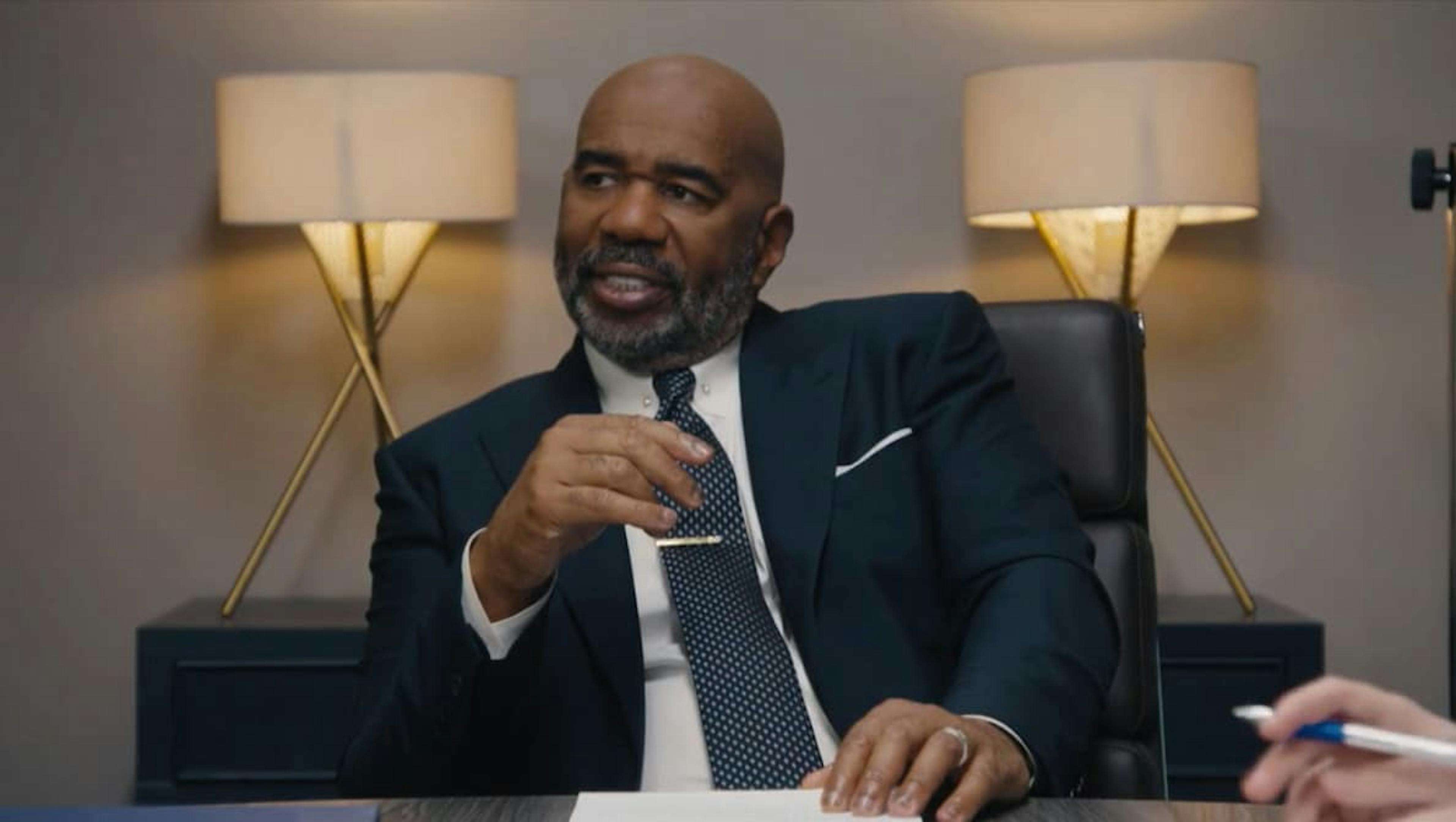 Man in suit sat at desk
