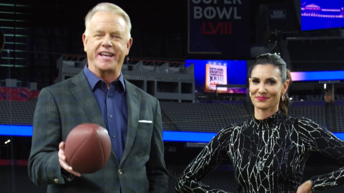 Man and woman stood next to each other and man holding a football