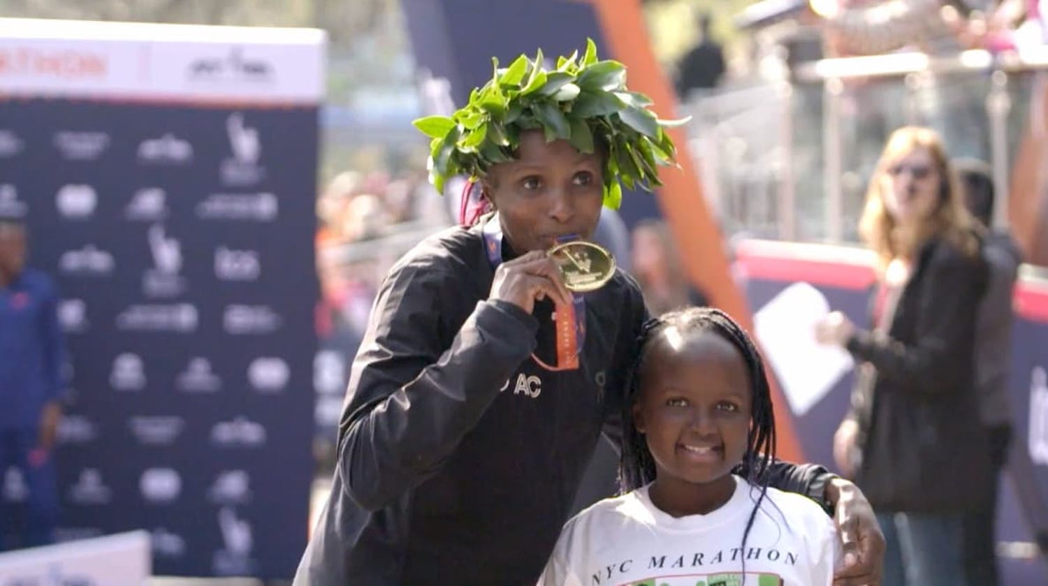 Woman and girl celebrating marathon win