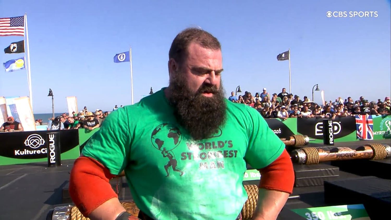 Man wearing 'World's Strongest Man' T-shirt