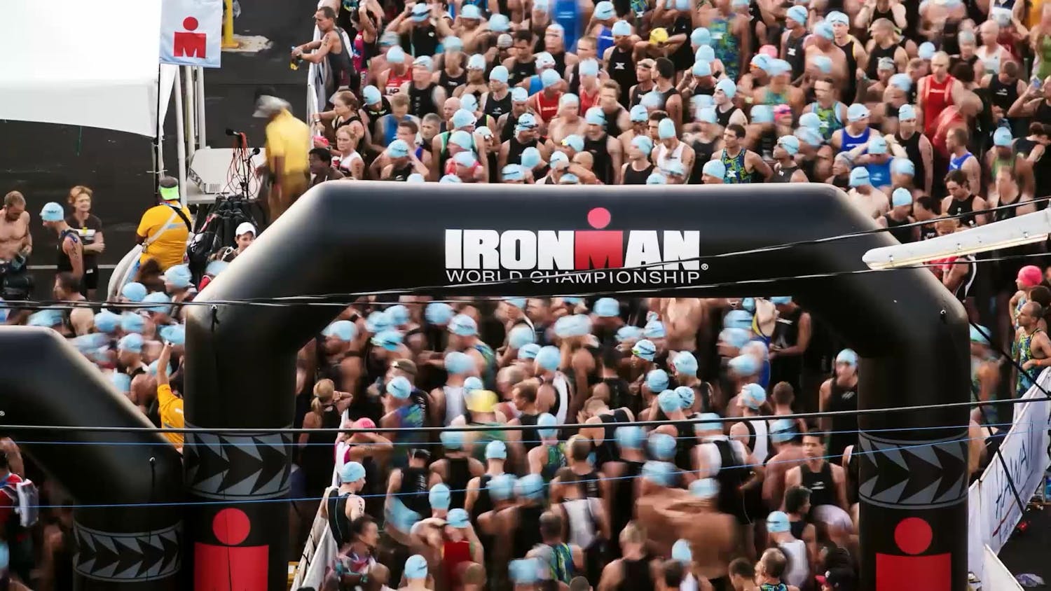 Crowd walking under Ironman arch