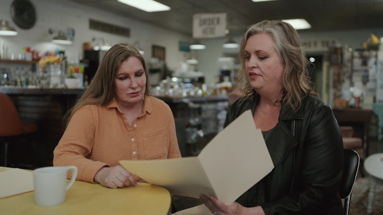 Two women looking at piece of paper