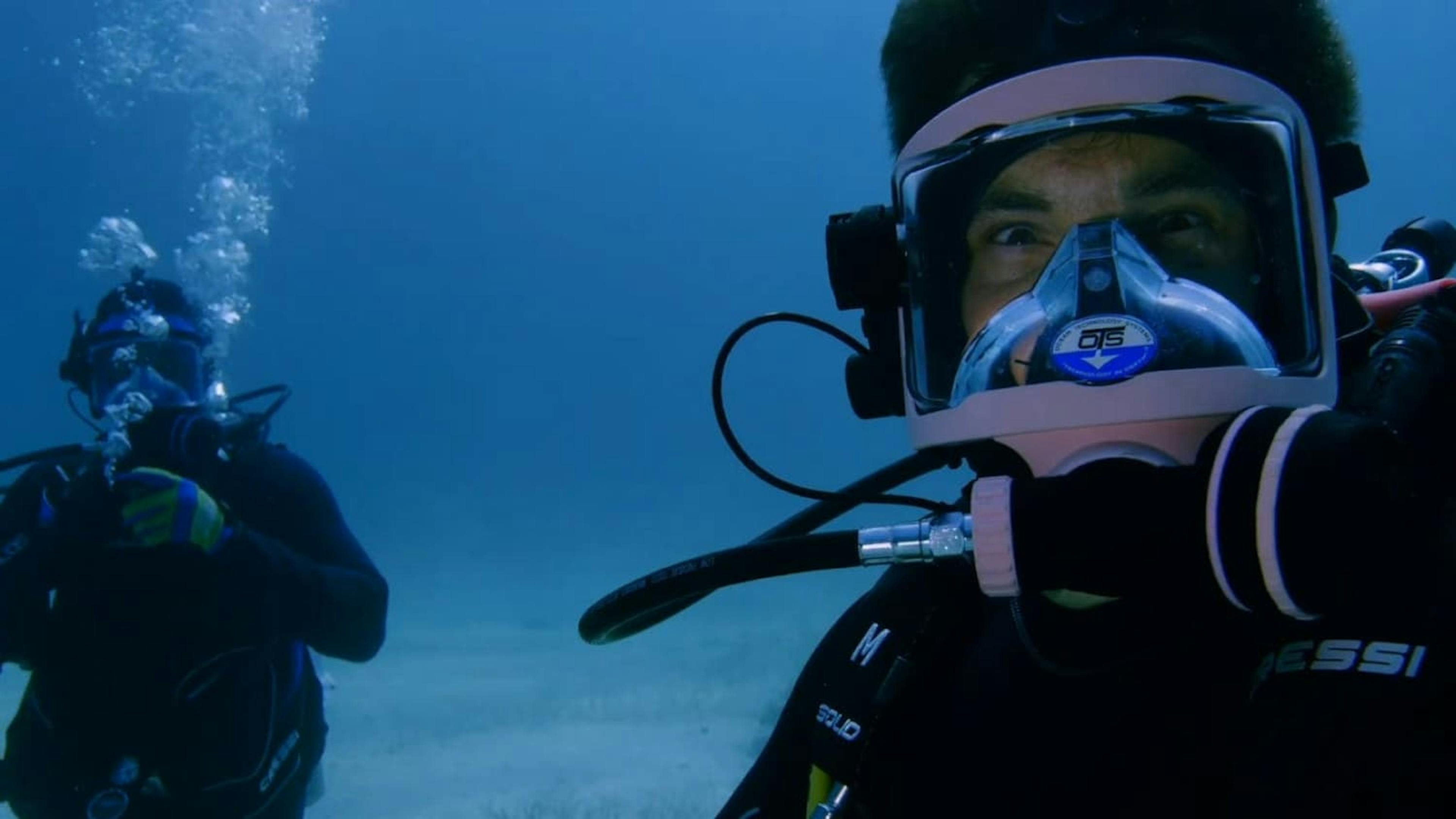 Diver underwater looking at camera