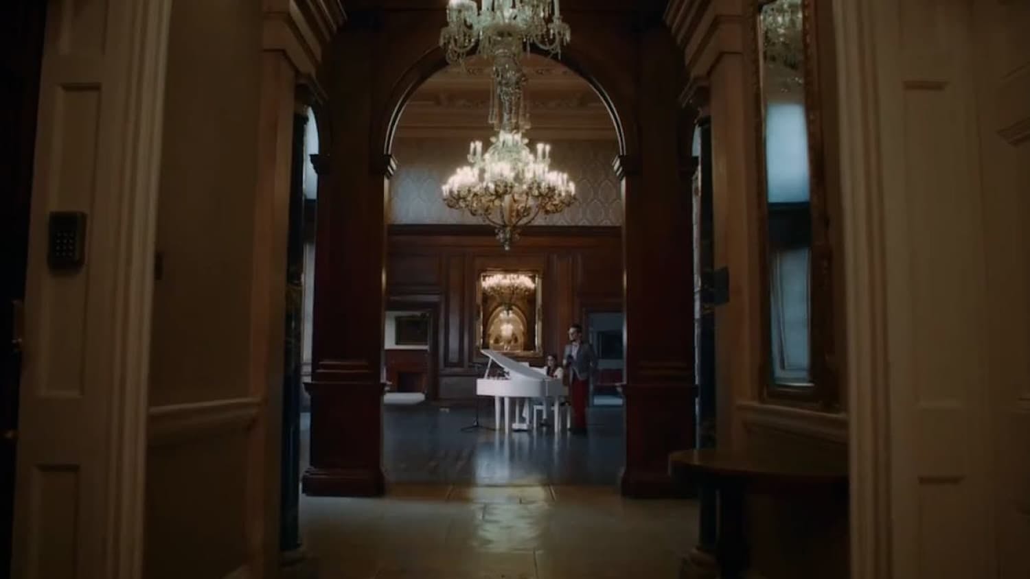 View of house hallway with chandelier 