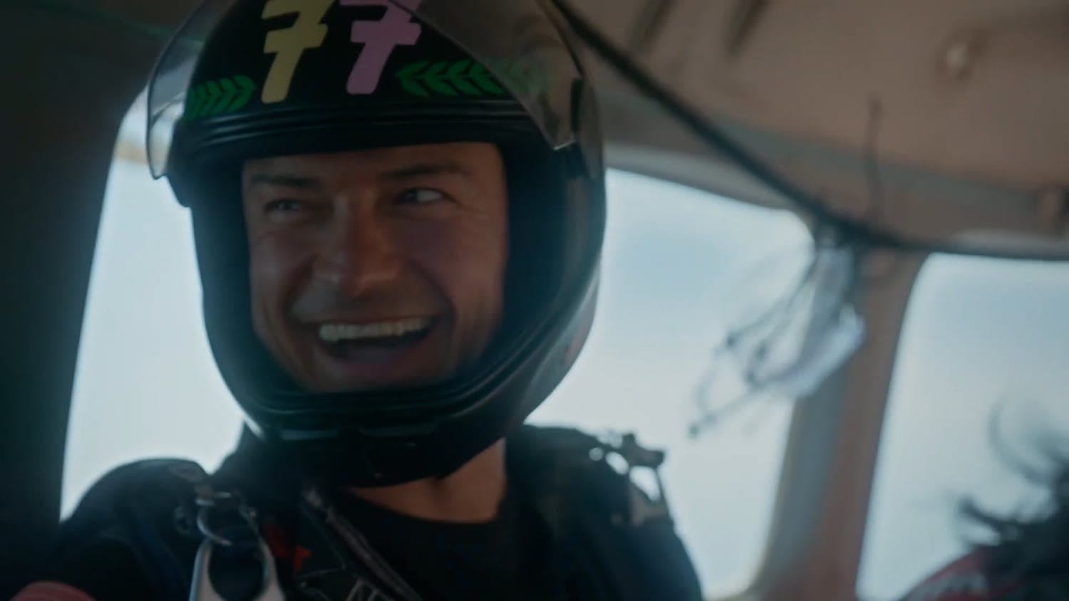 Orlando Bloom wearing helmet and smiling