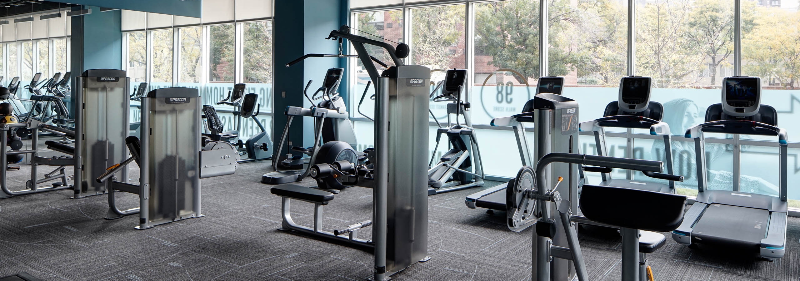 Interior view of the fitness center at AMLI Lofts featuring treadmills and elliptical machines as well as other equipment
