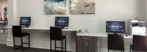 Interior view of cyber lounge with computer stations and printer at AMLI Memorial Heights apartment building