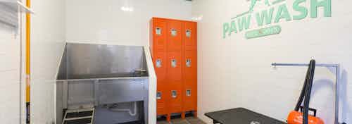 I Interior of paw wash at AMLI Campion Trail apartment building with stainless tub and lockers and grooming stand and dryer