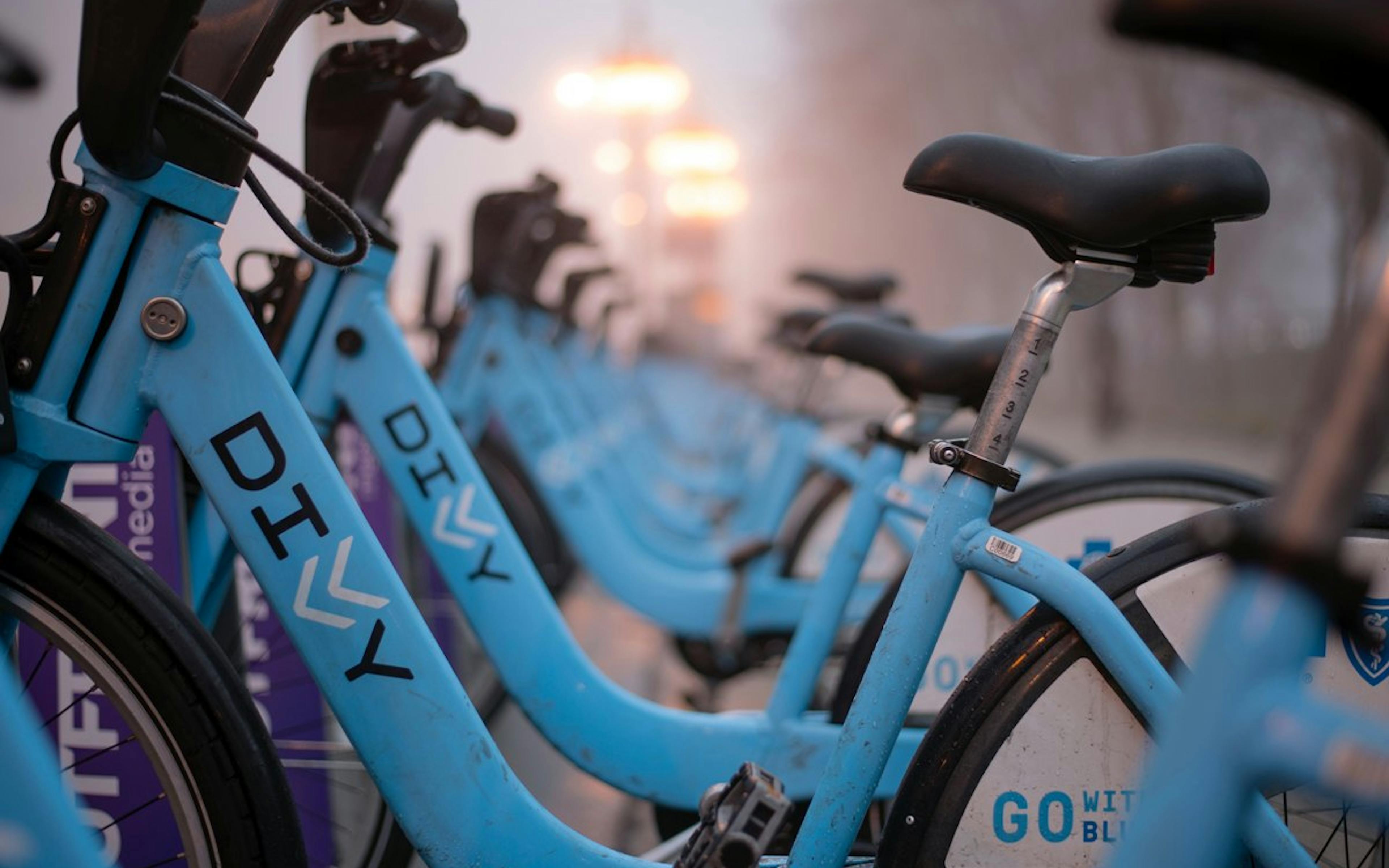 A close up image of parked blue Divvy bikes which represent a major bicycle sharing system unique to the city of Chicago
