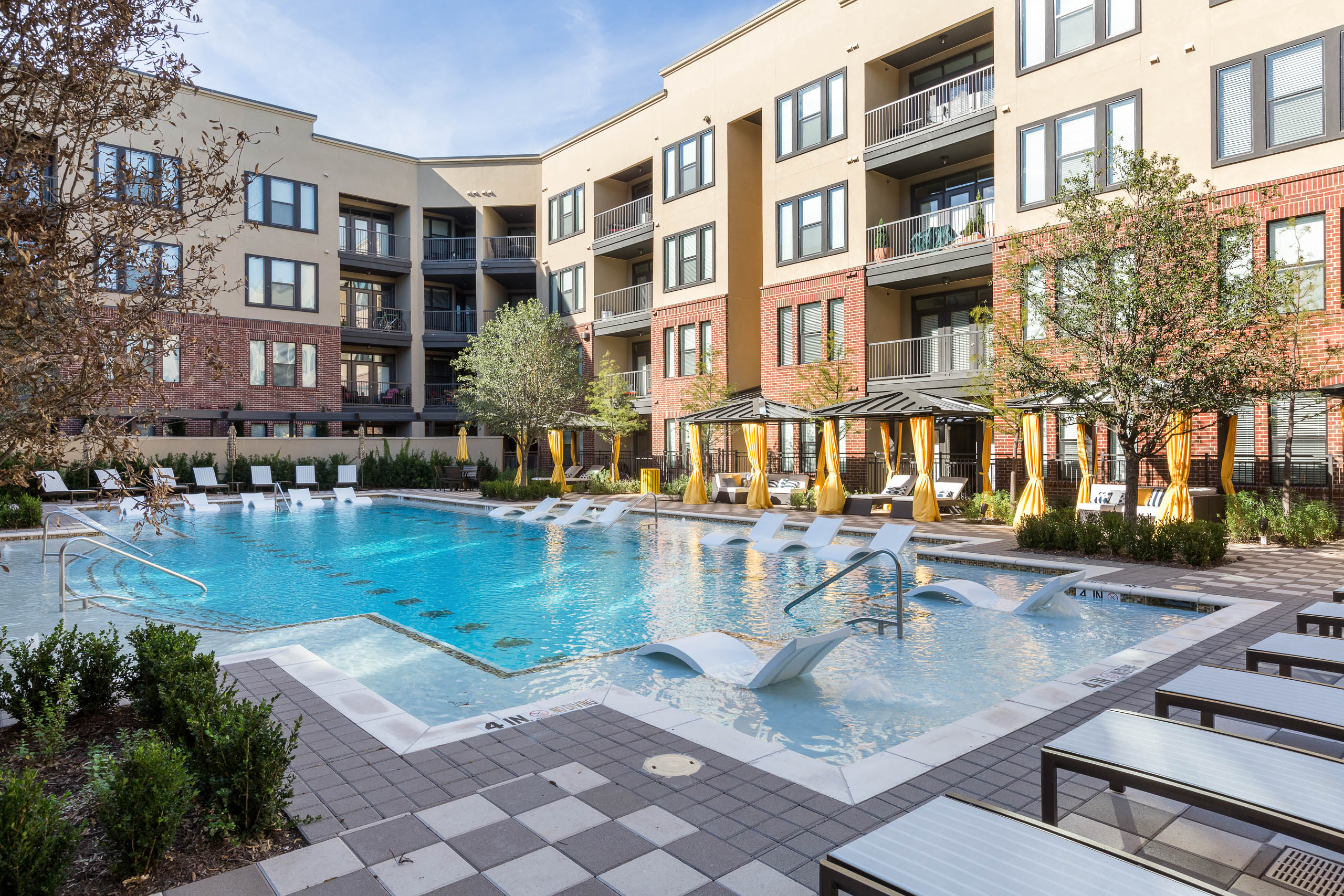 AMLI West Plano pool during the day with blue water