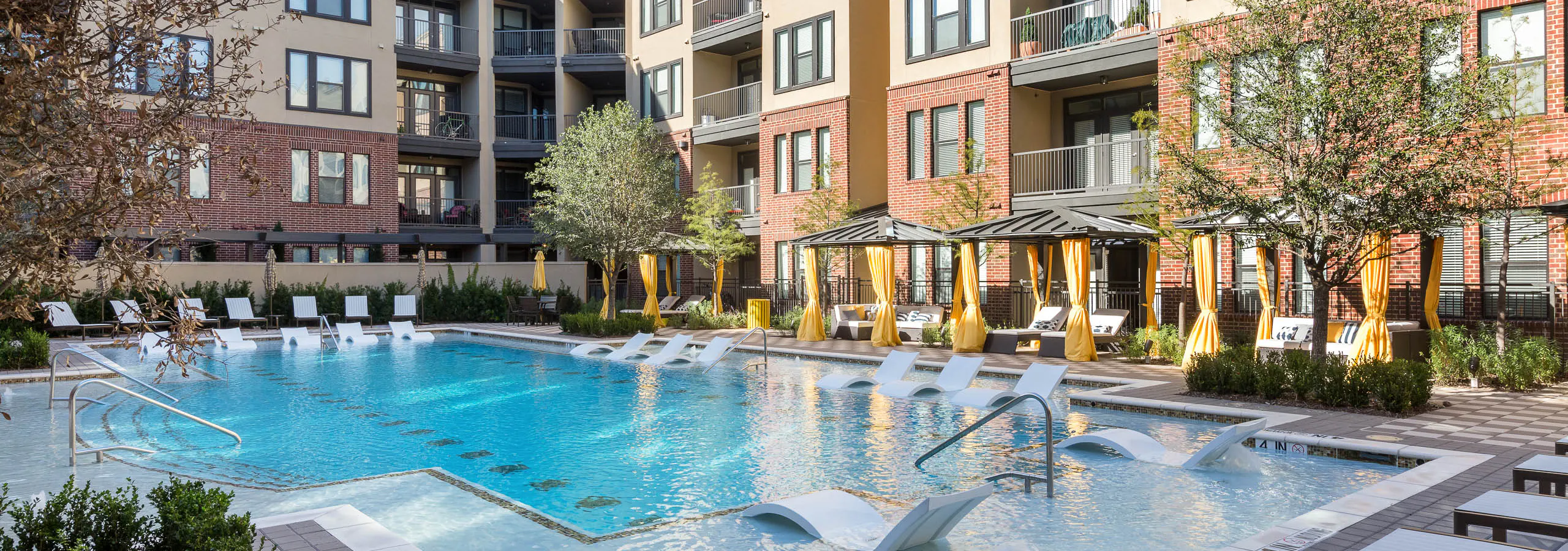 AMLI West Plano pool during the day with blue water