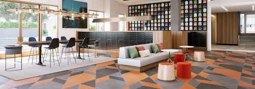 Rendering of AMLI Old Pasadena lobby and mailroom with bright geometric carpet flooring and tall windows with colorful decor