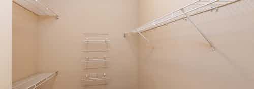 AMLI Memorial Heights apartment walk-in closet with built-in white wire shelves and beige walls