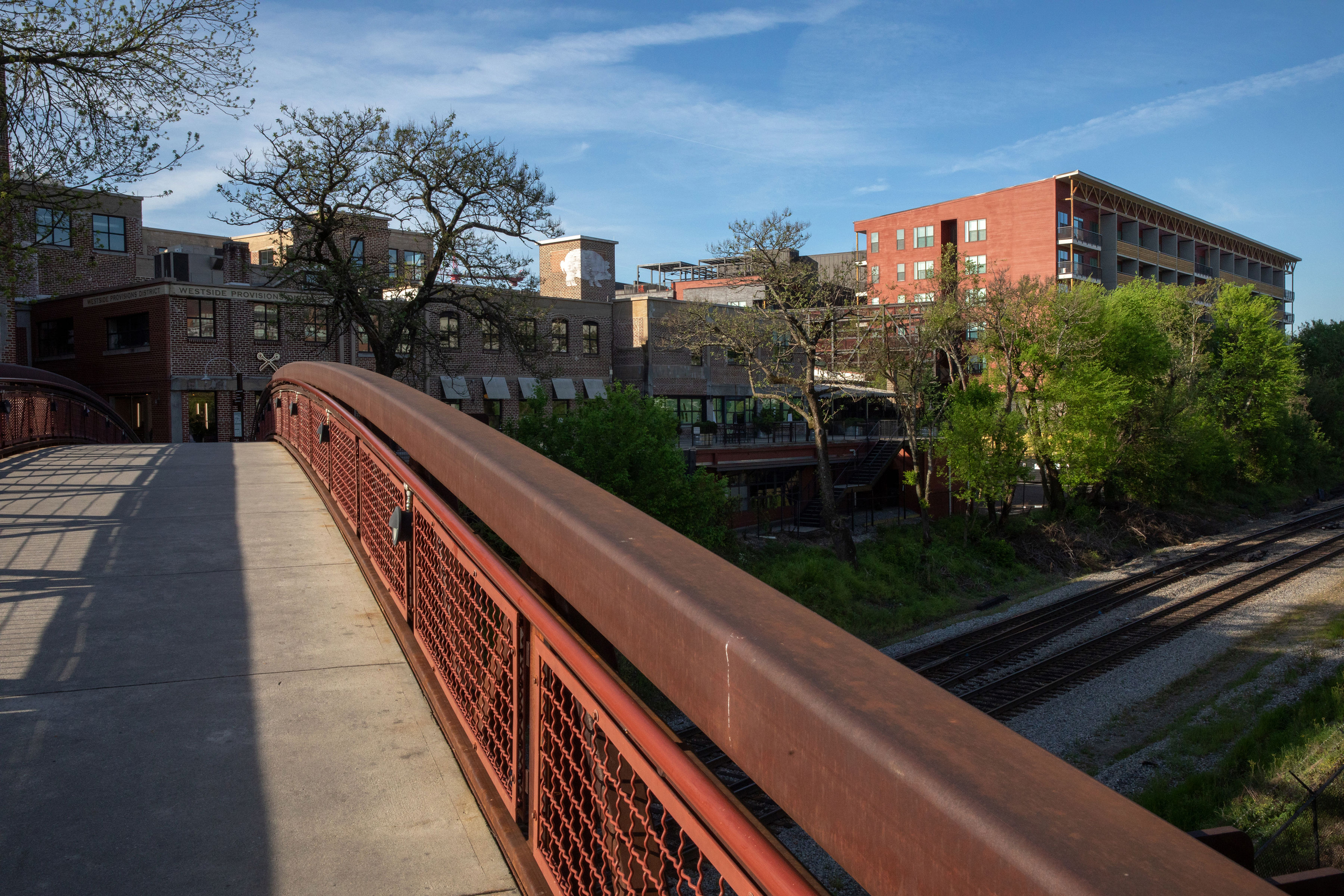 Exterior view of the scenic bridge that connects AMLI Westside to the Westside Provisions District on a sunny day