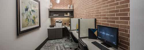 Interior of business center and java cafe at AMLI Las Colinas apartment building with computer stations and printer