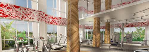 Fitness center at AMLI Park West with floor to ceiling windows endurance equipment and large wood grained columns