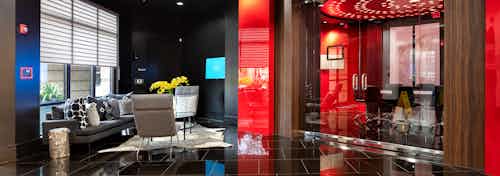 Interior view of AMLI Uptown apartment building clubhouse with seating area outside conference room with large glass doors