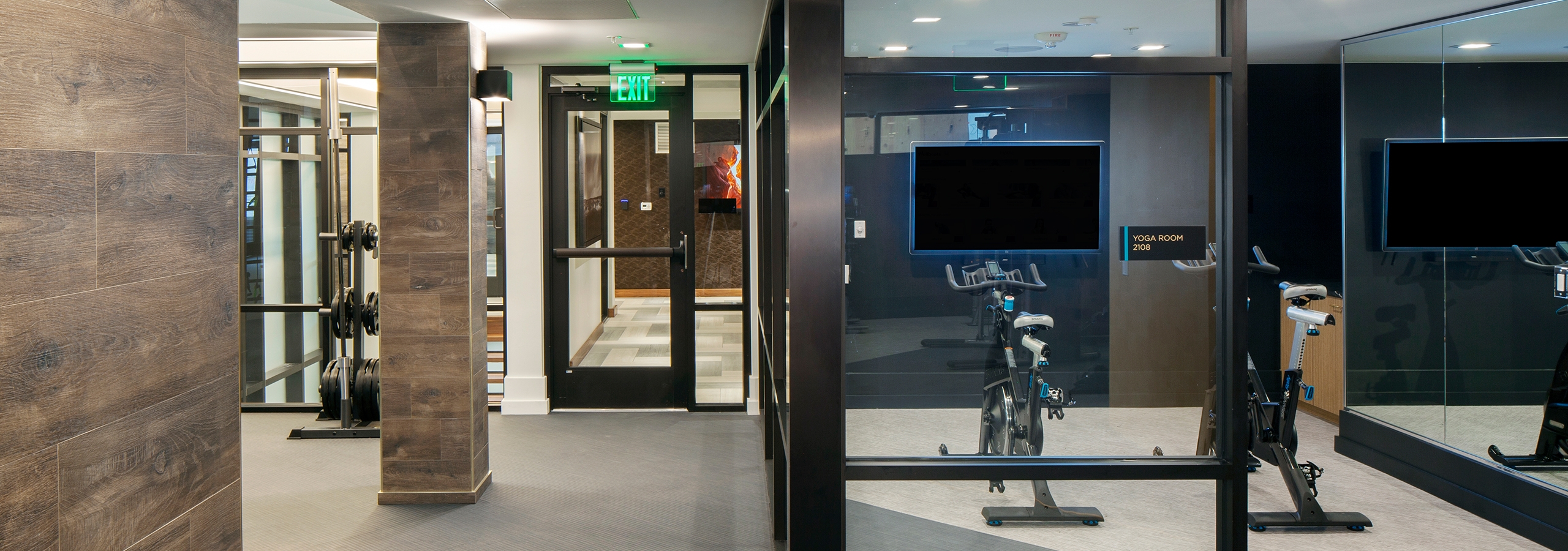 Spin cycles and fitness on demand featured at AMLI Riverfront Green apartments with a view into the elevator hallway