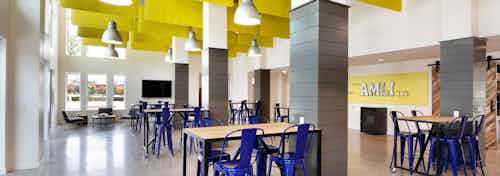 Interior of maker space with work tables for residents to gather and create at AMLI Frisco Crossing apartment building