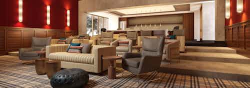 AMLI Old Pasadena theatre room rendering with red walls and patterned floors with neutral seating and kitchen in background