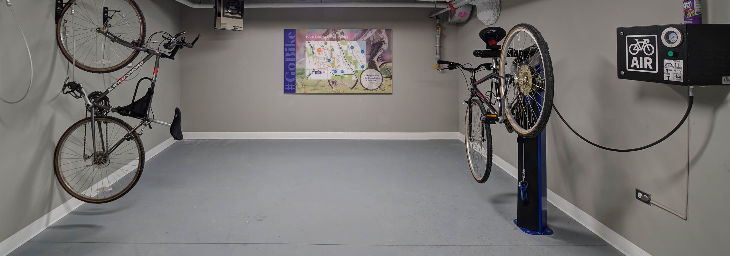 Interior of bike work room amenity at AMLI Deerfield apartment community equipped with repair station and bike map