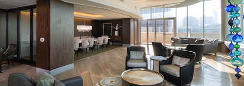 Interior view of sky lounge at AMLI Design District apartment building with various seating areas and conference room in back