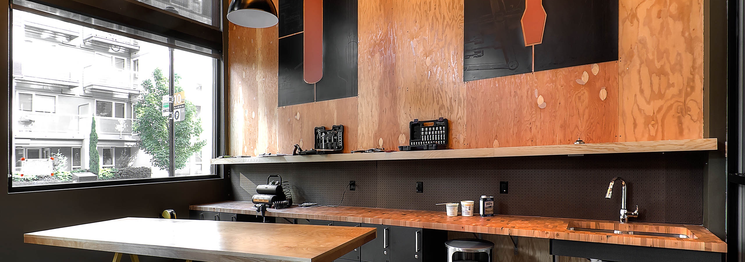 The woodworking space in the DIY maker space at AMLI South Lake Union apartments with work bench and tools