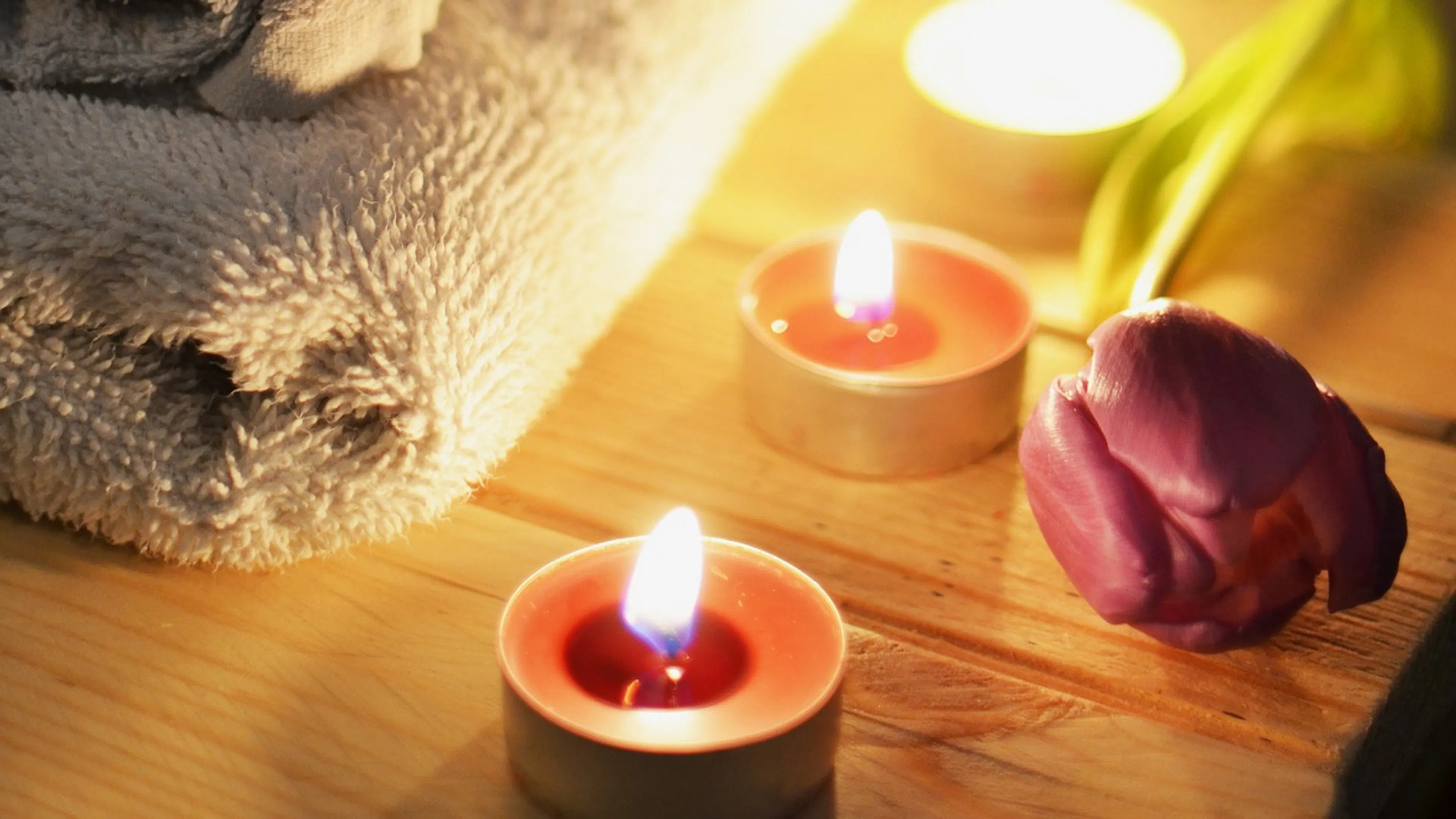 Massage treatment with towels and candles