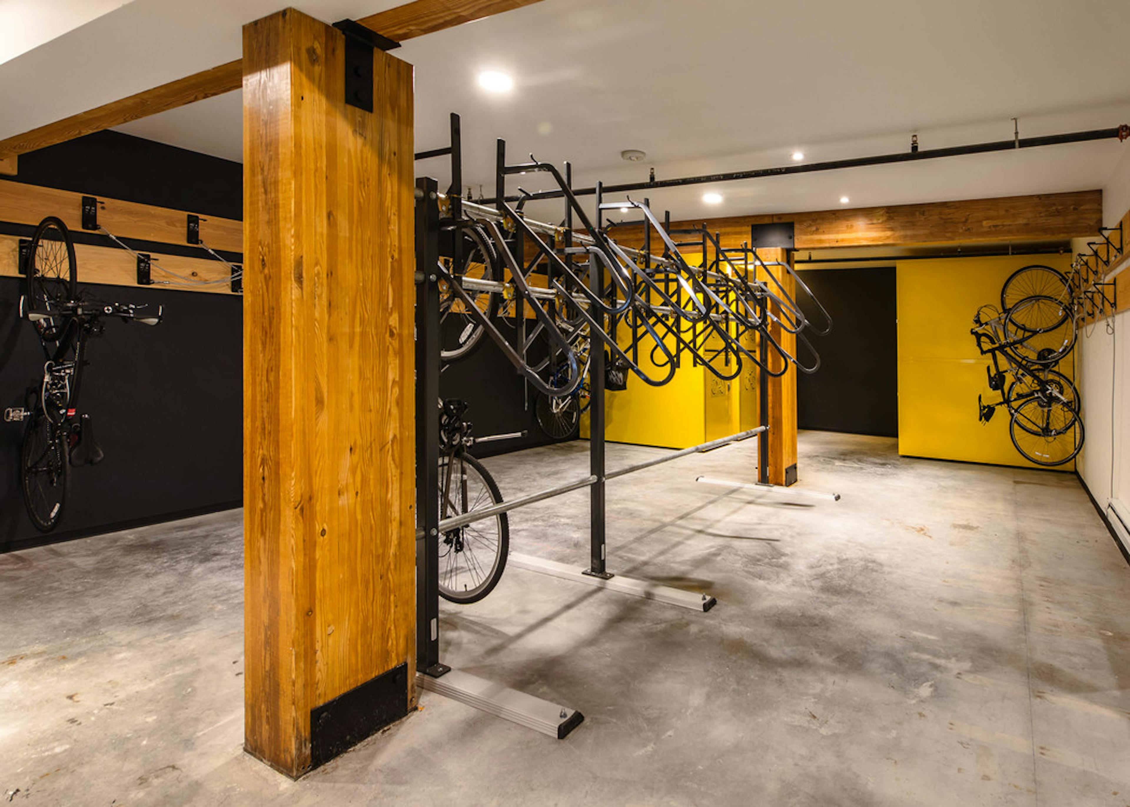 Second bike room at AMLI Wallingford with bike storage tools and yellow and dark blue colorful walls