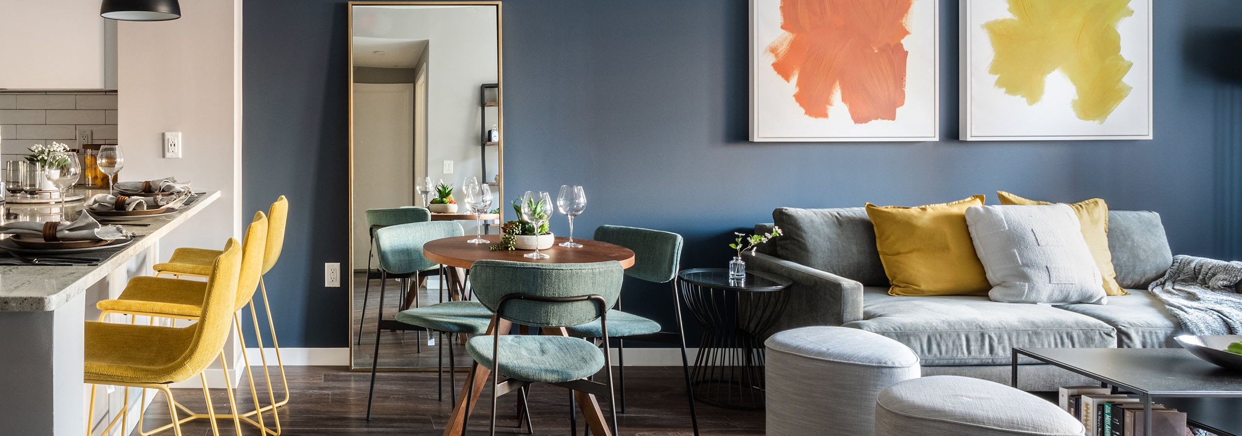 AMLI at Uptown apartment living room and dining area featuring vibrant colored decor and modern furniture selections