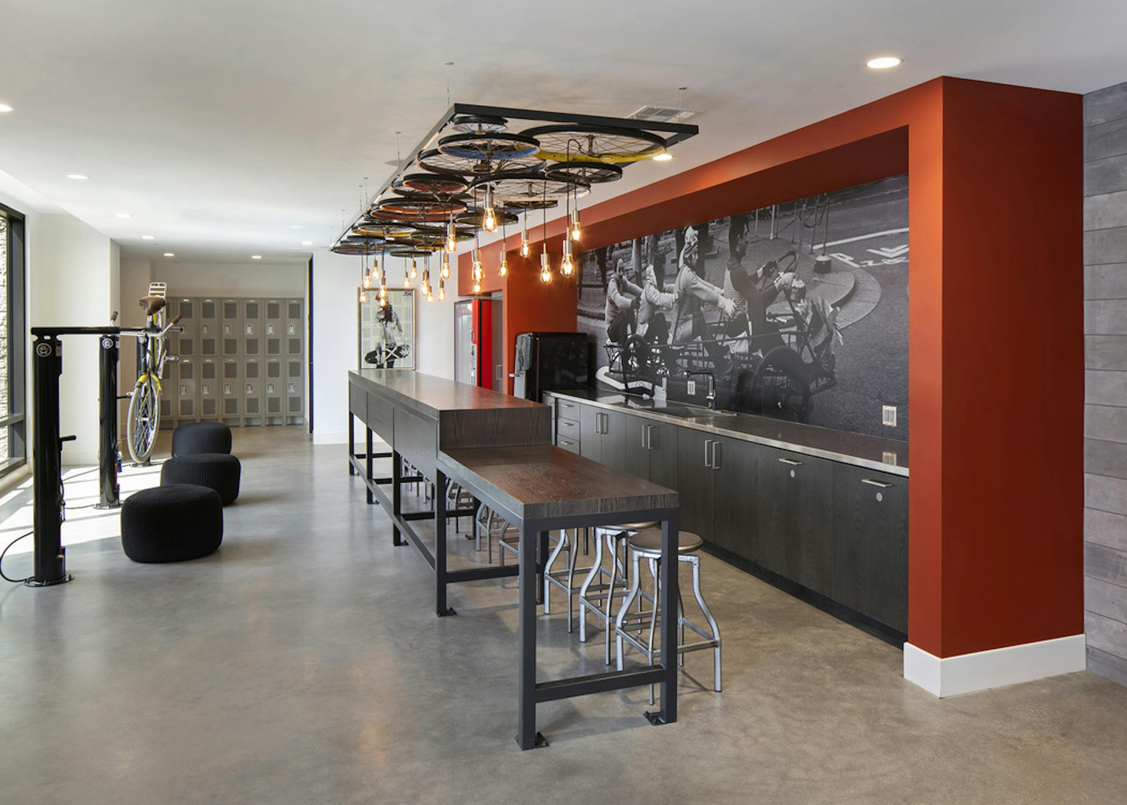 Interior of AMLI Marina Del Rey SPOKE bike repair room with tools, storage lockers and work counter and rope pendant lights