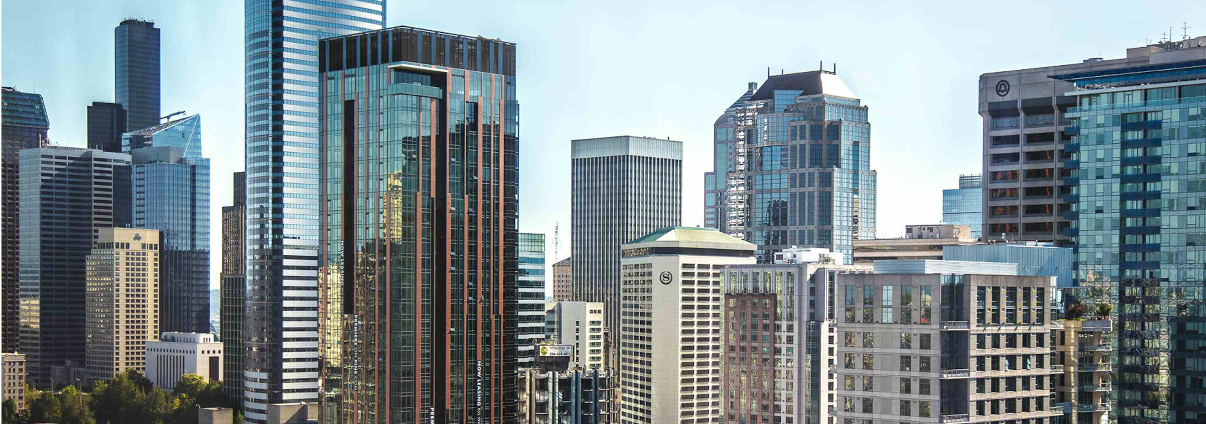 Beautiful sunny day with blue skies exterior view from AMLI Arc of downtown Seattle skyline with tons of tall buildings 