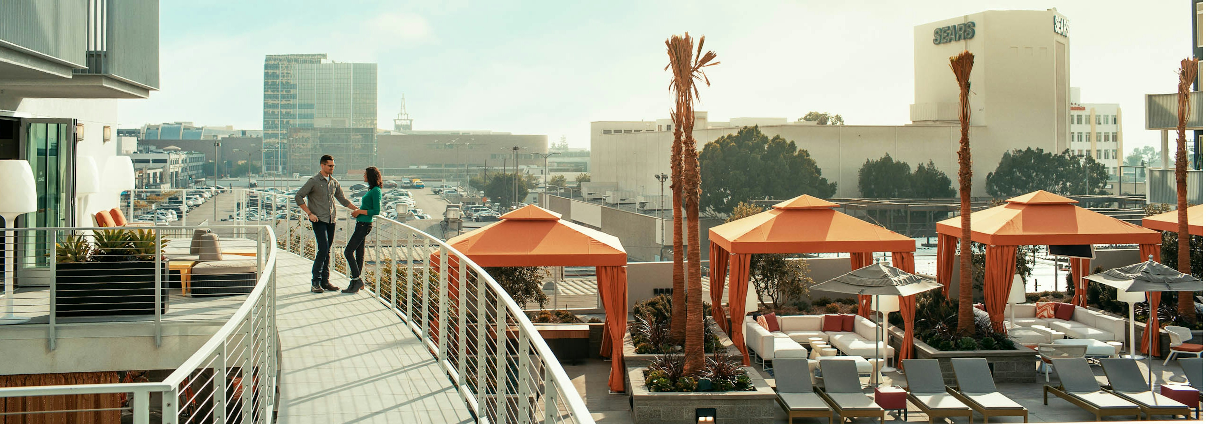 Daytime exterior view of AMLI Lex on Orange apartment building VIP lounge overlooking the city and pool deck with cabanas