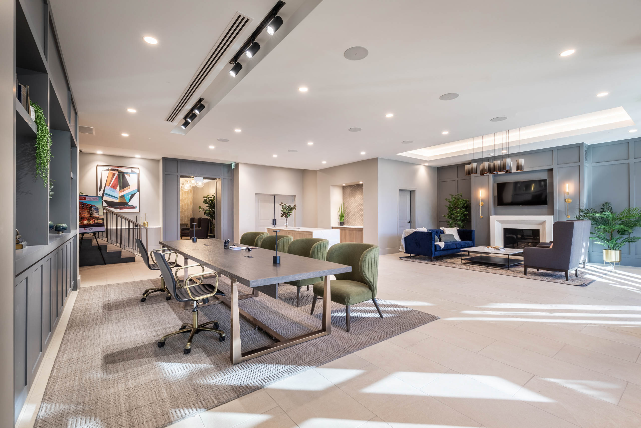 Close up of spacious conference table in AMLI at Uptown lobby with view of seating area and modern fireplace in background