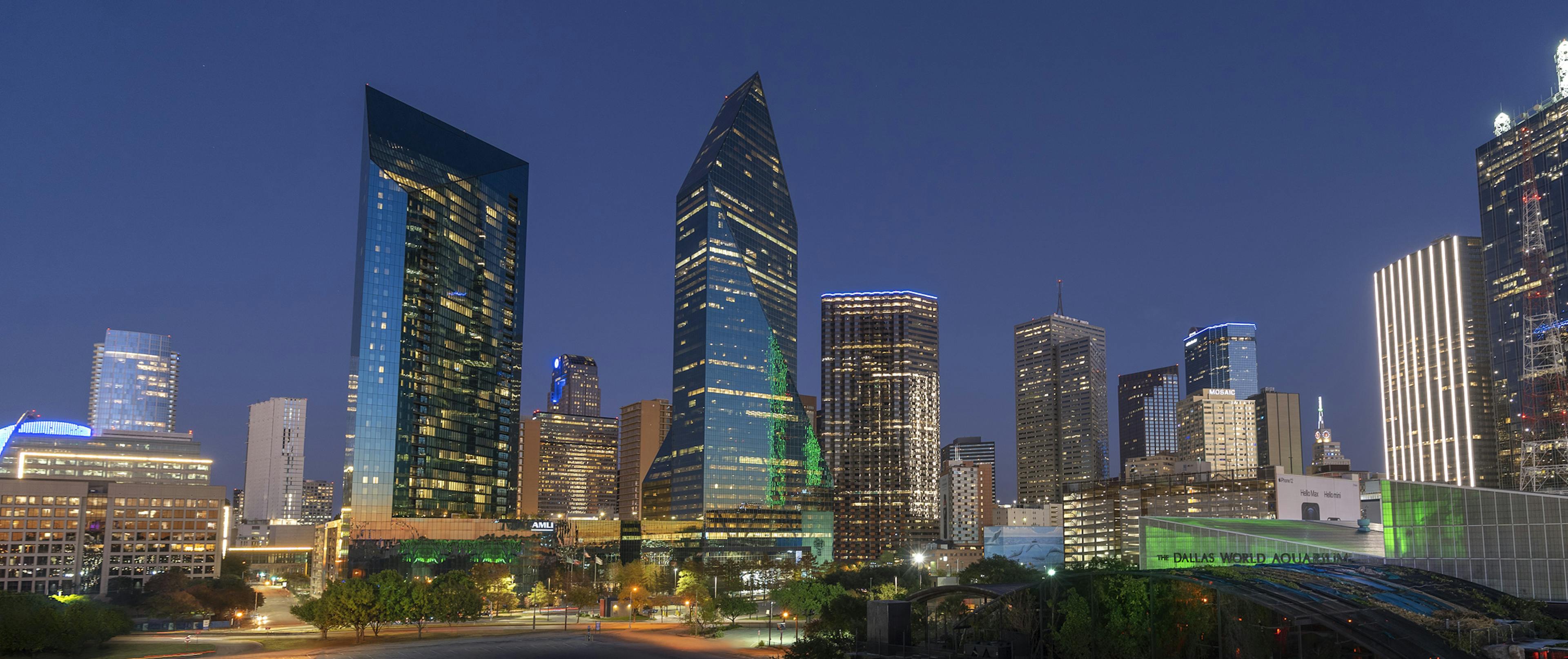 Nighttime city view of AMLI Fountain Place apartment building and Fountain Place corporate office building