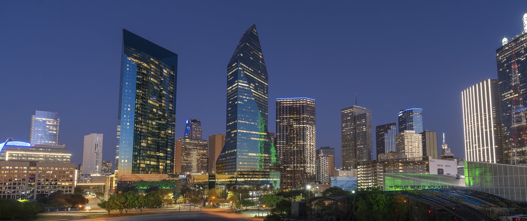 Nighttime city view of AMLI Fountain Place apartment building and Fountain Place corporate office building
