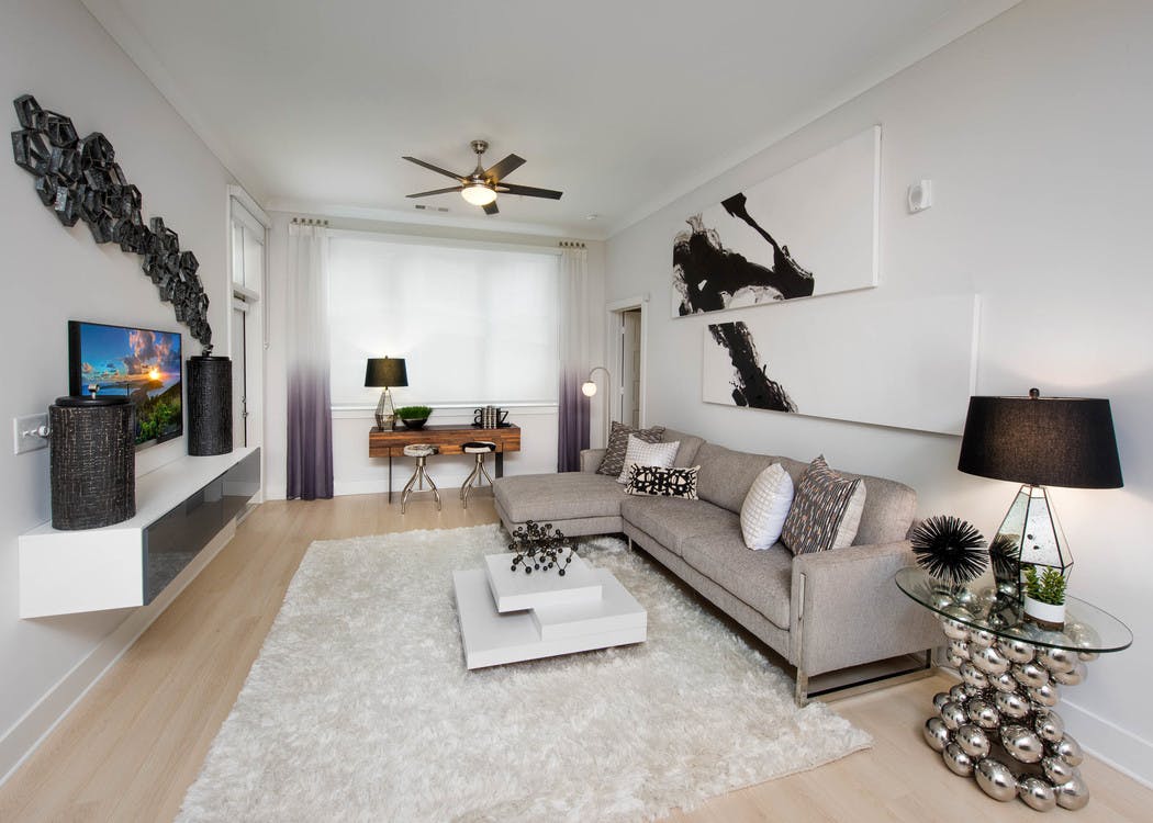 Alternate angle of AMLI Buckhead living room with black, white and beige color scheme with creme walls and light wood floors