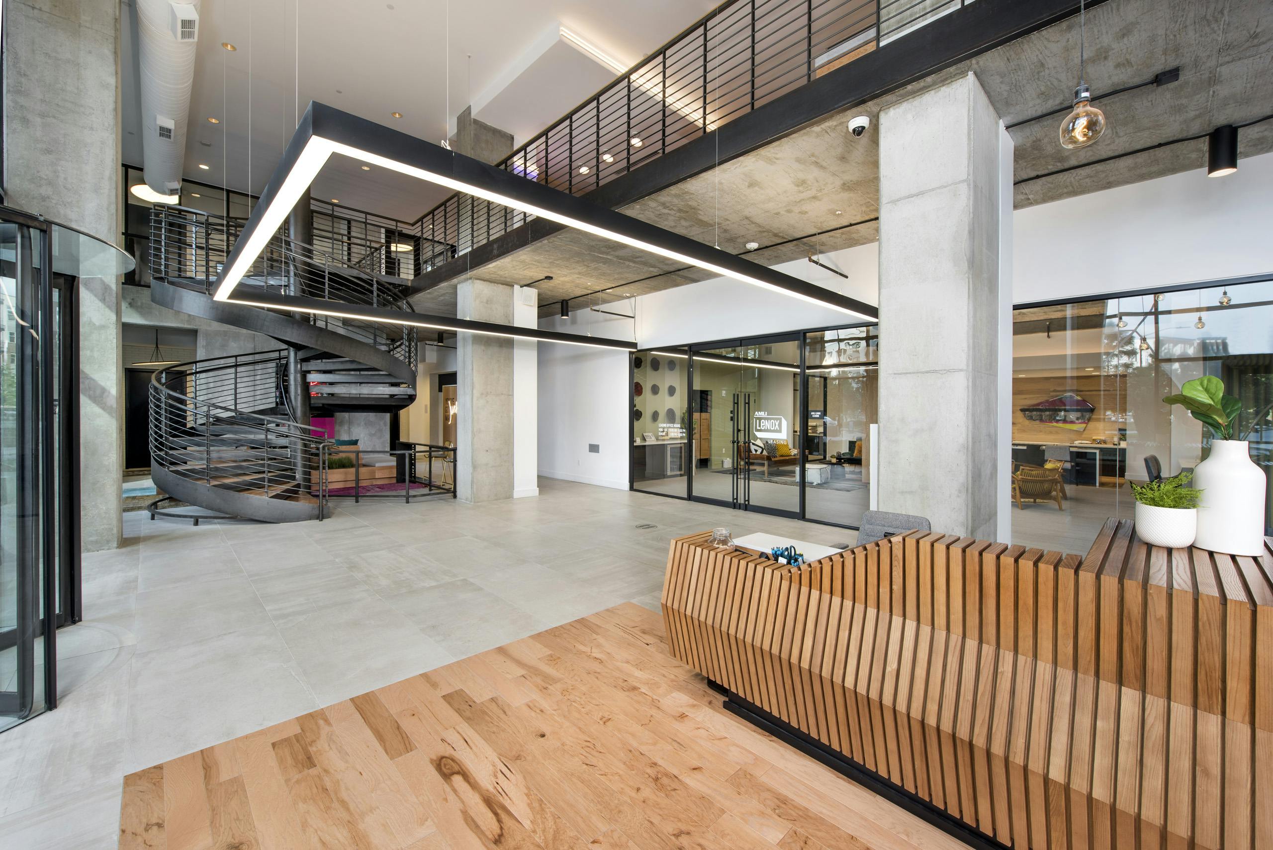 Interior view of downstairs entrance of AMLI Lenox leasing office with spiral staircase leading to the second floor